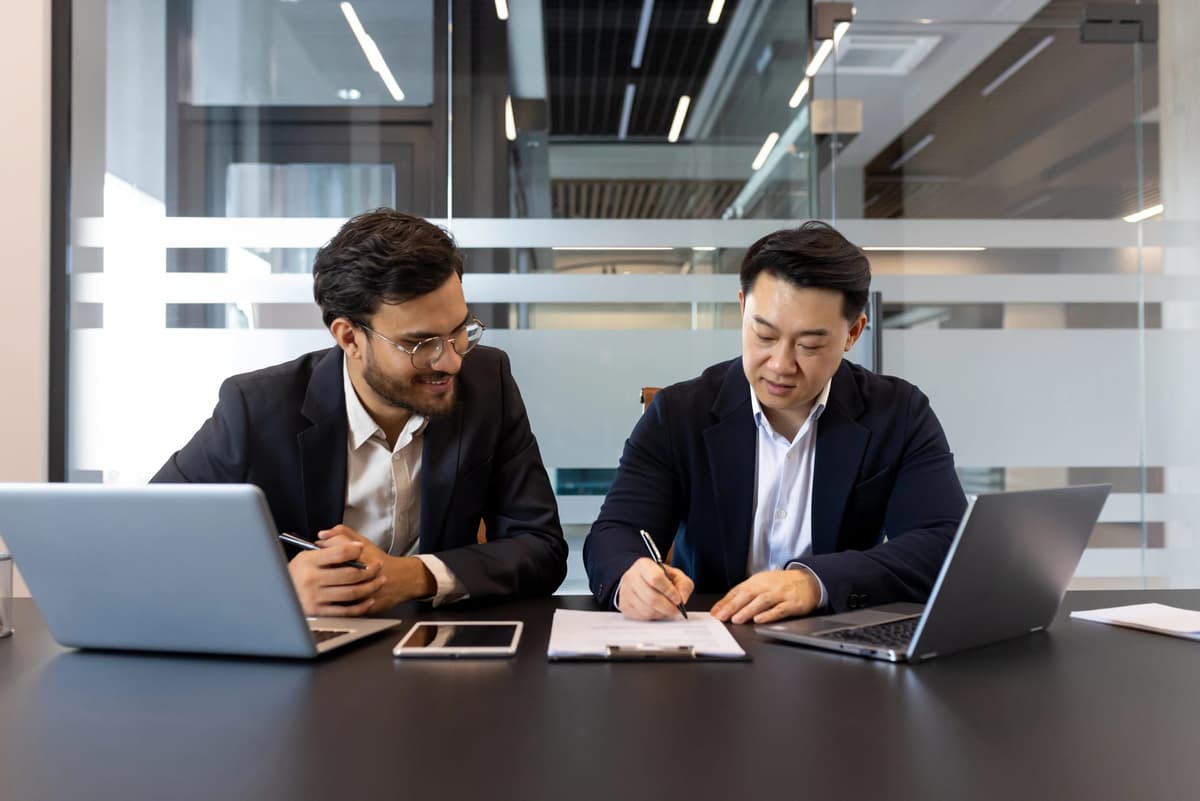 Two professionals reviewing documents together at a desk